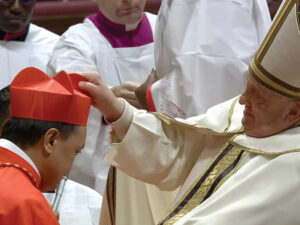 Pope Francis places a red biretta on new Cardinal Pablo Virgilio David of Kalookan during a consistory to create 21 new cardinals in St. Peter’s Basilica at the Vatican, Dec. 7, 2024 (Screenshot by CBCP News from Vatican News)